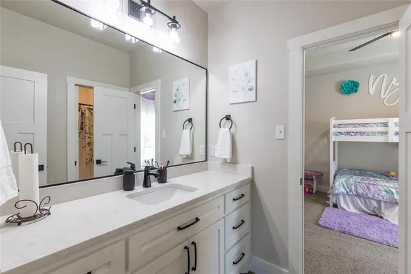 a bedroom with a bed a chandelier and closet