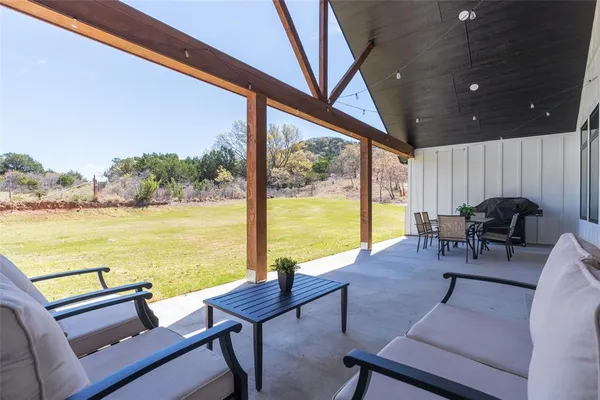 a view of a patio with lake view and wooden floor