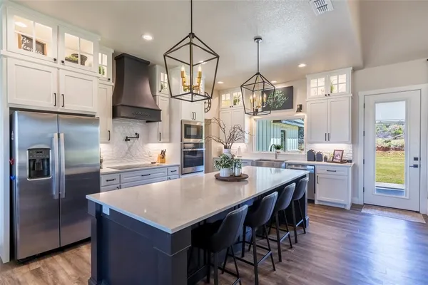 a kitchen with counter top space and wooden floor