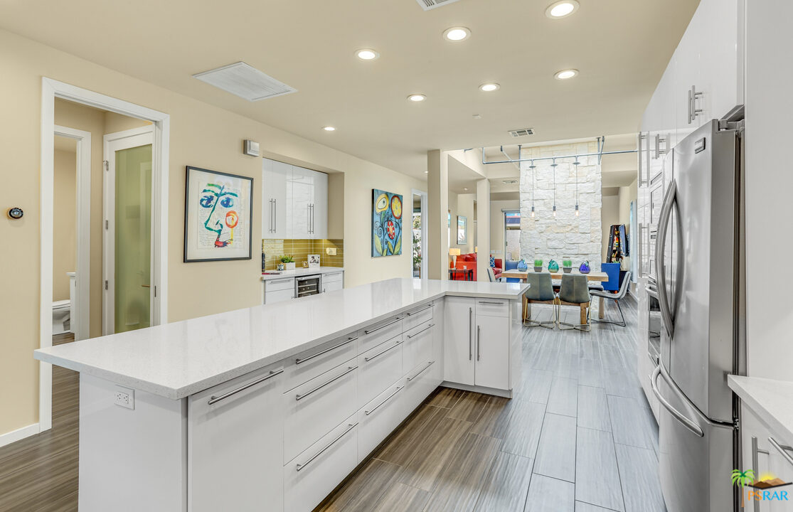 a large white kitchen with a large window