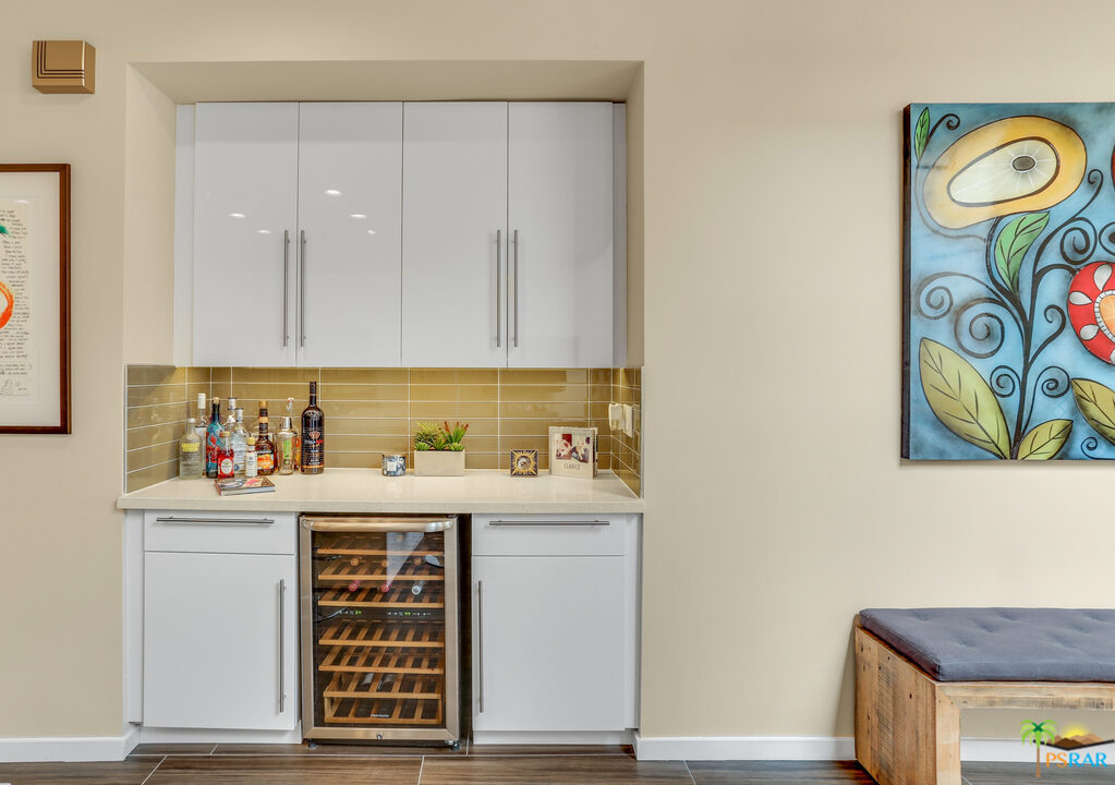 1314 East Andreas Road Palm Springs, CA 92262 - Photo 14 of 34 a view of a kitchen with fridge and wooden floor