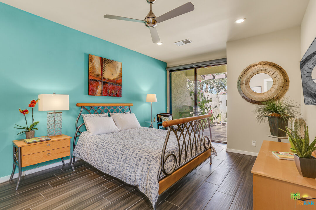 1314 East Andreas Road Palm Springs, CA 92262 - Photo 18 of 34 a bedroom with a bed and wooden floor