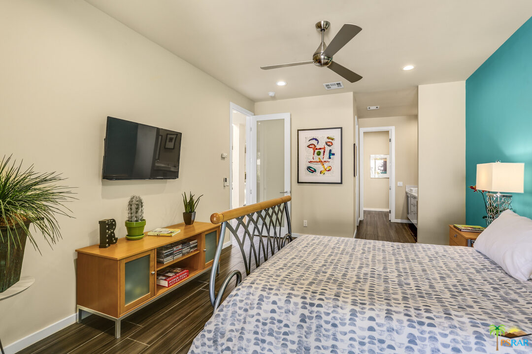 1314 East Andreas Road Palm Springs, CA 92262 - Photo 19 of 34 a bedroom with a bed and a flat screen tv