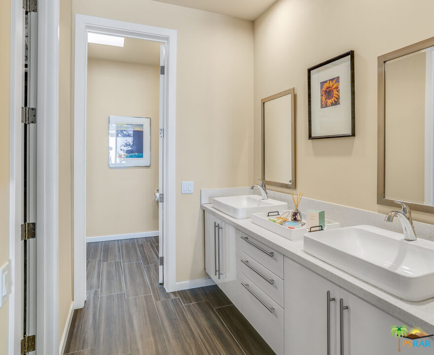 1314 East Andreas Road Palm Springs, CA 92262 - Photo 20 of 34 a spacious bathroom with a double vanity sink and a mirror