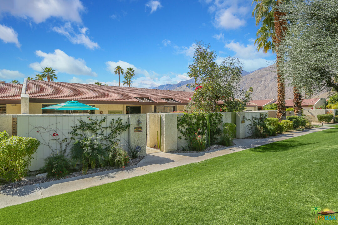 1314 East Andreas Road Palm Springs, CA 92262 - Photo 2 of 34 a view of a garden with a building in the background