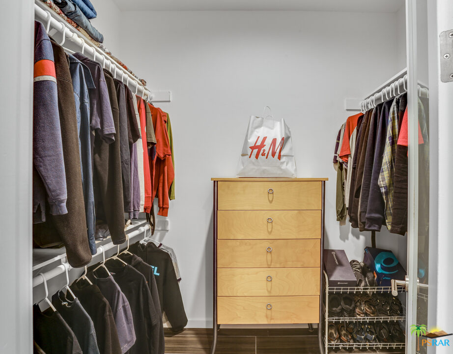 1314 East Andreas Road Palm Springs, CA 92262 - Photo 22 of 34 a view of walk in closet with clothes and shoes