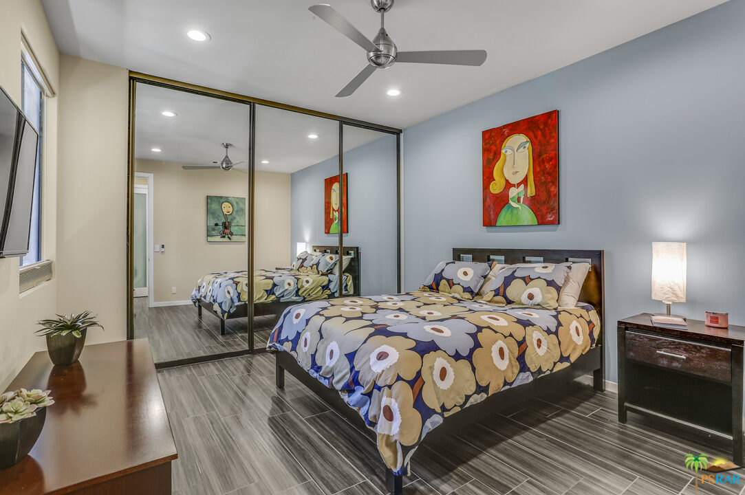 1314 East Andreas Road Palm Springs, CA 92262 - Photo 23 of 34 a bedroom with bed and wooden floor