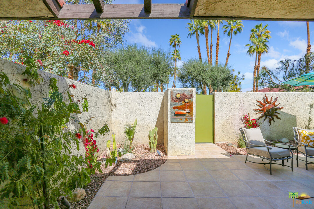 1314 East Andreas Road Palm Springs, CA 92262 - Photo 30 of 34 a view of a swimming pool with plants