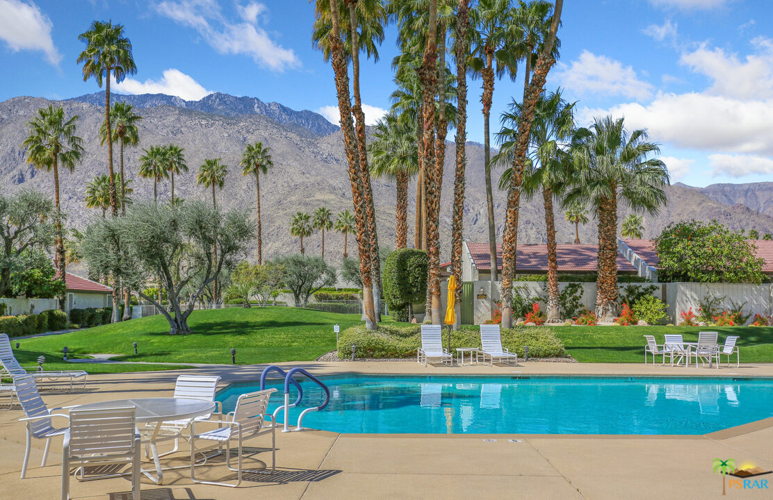 1314 East Andreas Road Palm Springs, CA 92262 - Photo 33 of 34 a view of a swimming pool with a garden and palm trees