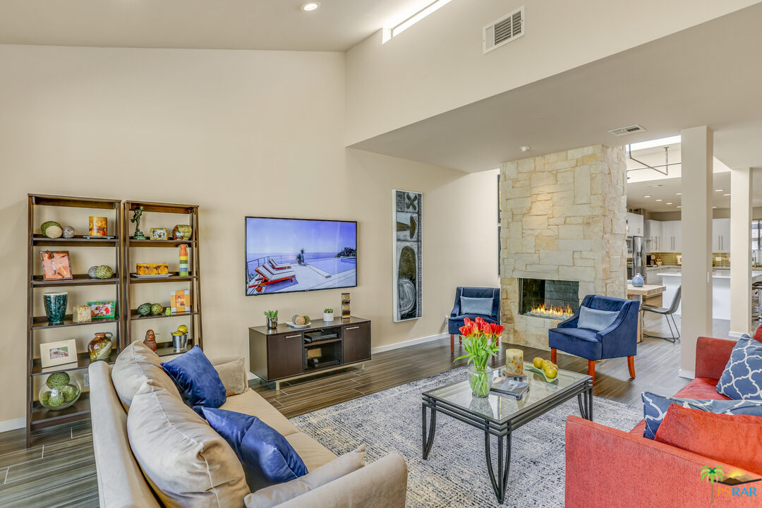 1314 East Andreas Road Palm Springs, CA 92262 - Photo 8 of 34 a living room with furniture a rug and a fireplace