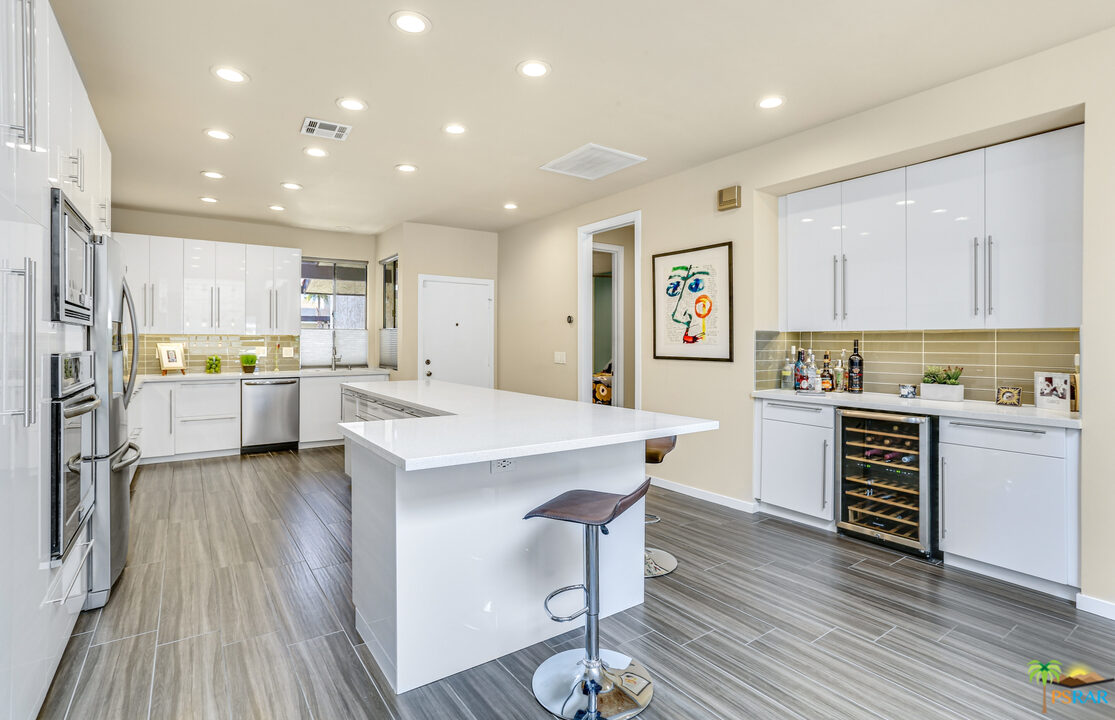 1314 East Andreas Road Palm Springs, CA 92262 - Photo 10 of 34 a kitchen with a refrigerator and a stove top oven