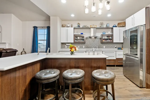 a large kitchen with stainless steel appliances kitchen island granite countertop a sink and cabinets