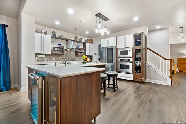 a kitchen with sink cabinets and wooden floor