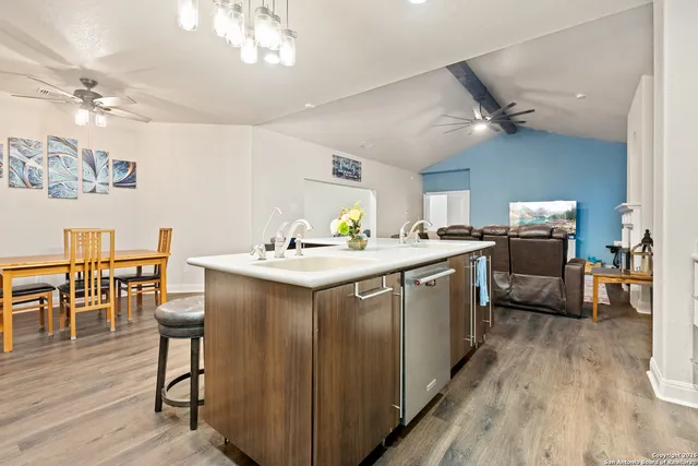 a kitchen with a sink stove and cabinets