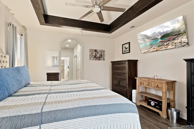 a bedroom with a bed couch and window