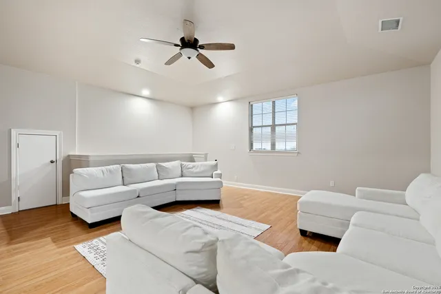 a view of a house with a big yard and large trees