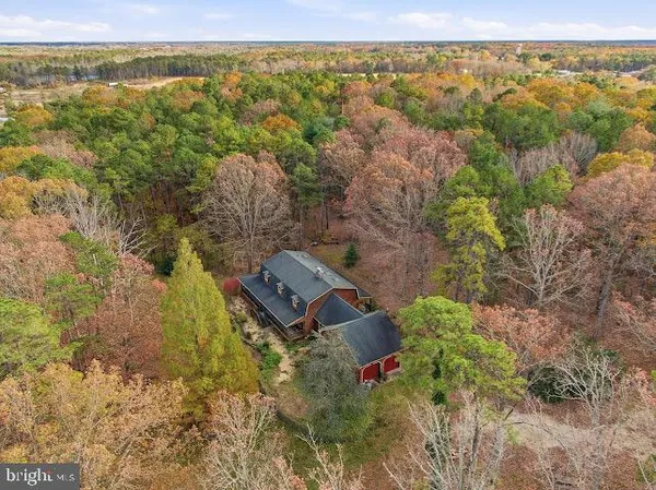 an aerial view of a house with a lake view