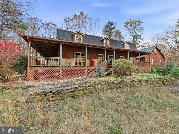 a front view of house with a garden