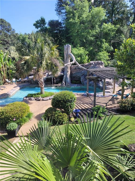 1679 Rangewood Drive Southwest Lilburn, GA 30047 - Photo 1 of 22 a view of a garden with plants and large trees