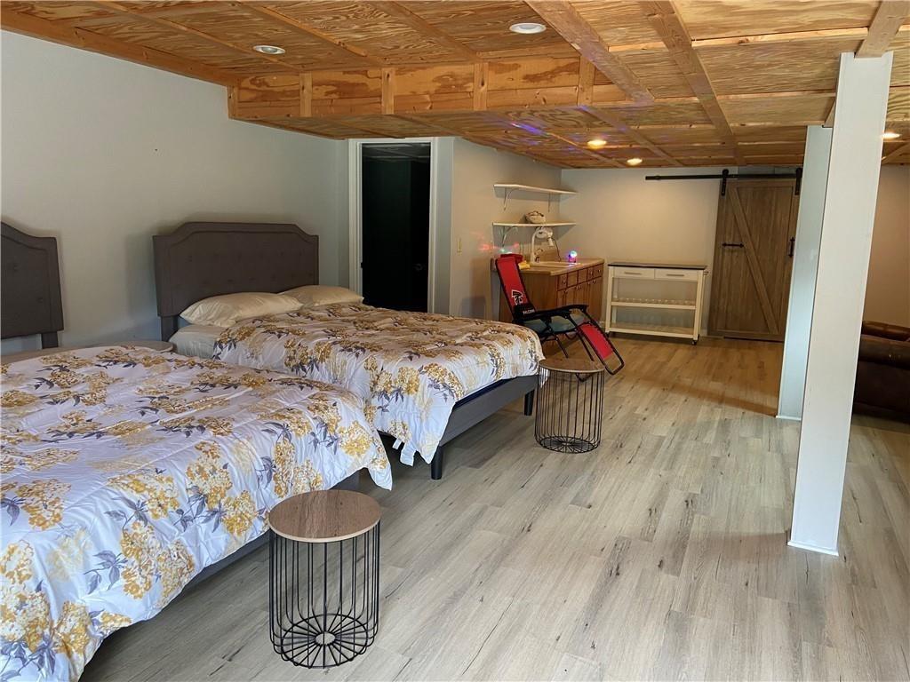 1679 Rangewood Drive Southwest Lilburn, GA 30047 - Photo 18 of 22 a bedroom with a bed and wooden floor