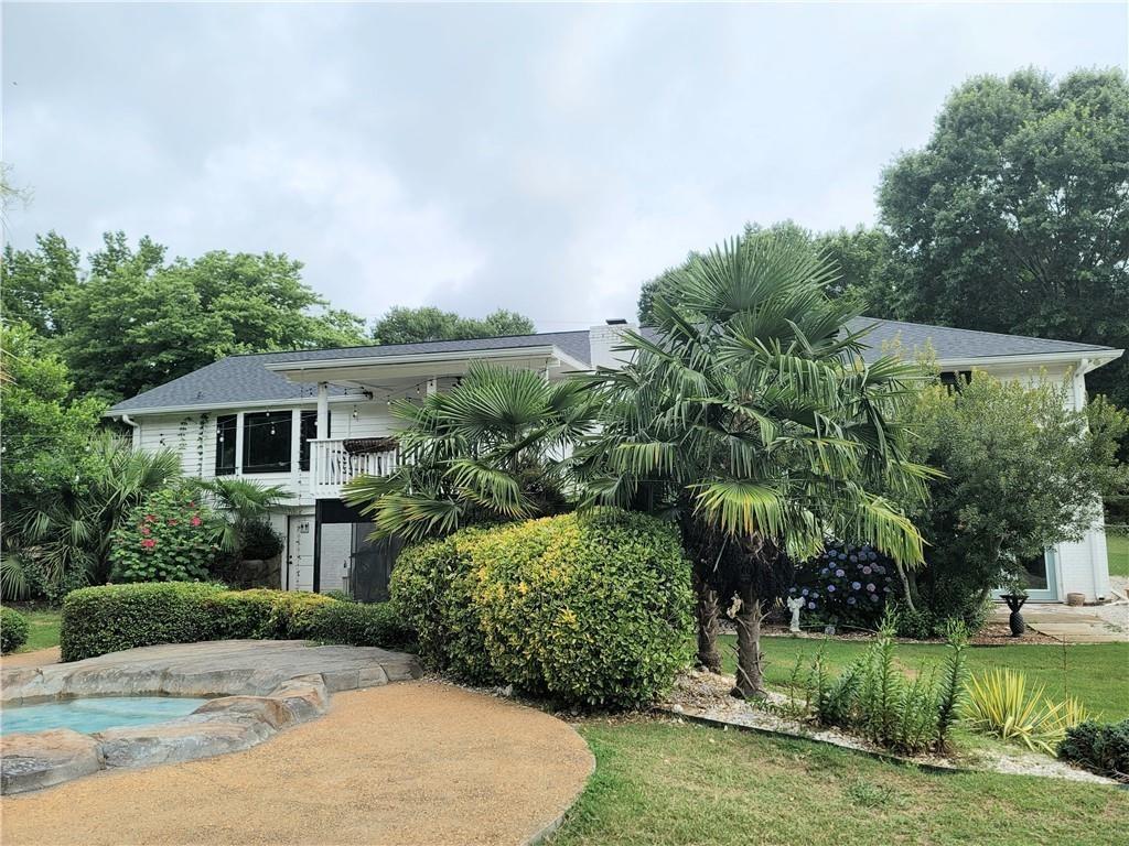1679 Rangewood Drive Southwest Lilburn, GA 30047 - Photo 7 of 22 front view of a house with a yard