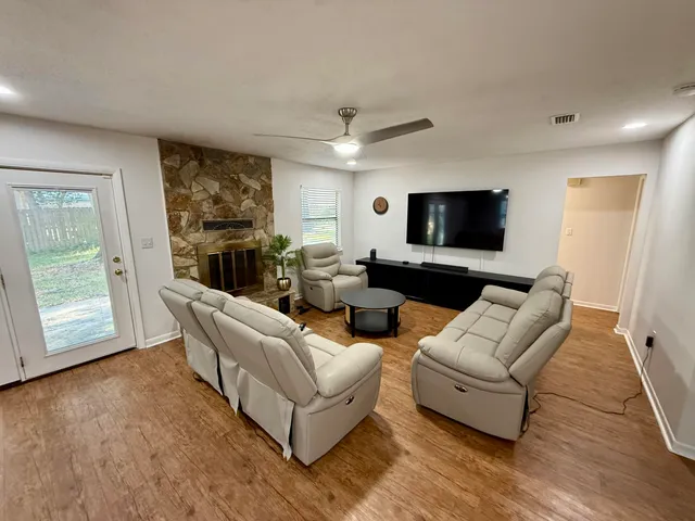 a living room with furniture and a flat screen tv