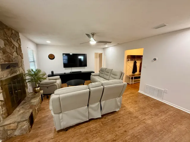 a living room with furniture and a flat screen tv
