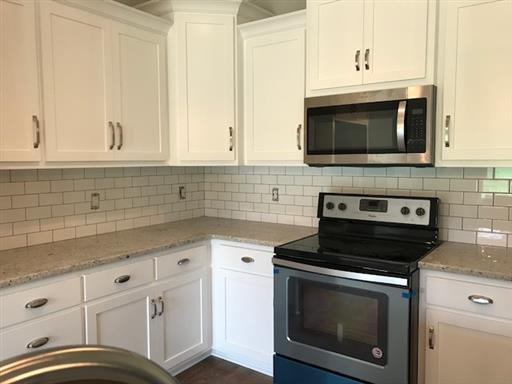 40 Cedar Grove Road Lebanon, TN 37087 - Photo 5 of 16 a kitchen with granite countertop white cabinets stainless steel appliances and sink