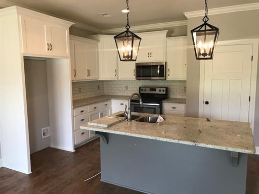 40 Cedar Grove Road Lebanon, TN 37087 - Photo 7 of 16 a kitchen with stainless steel appliances granite countertop a sink a stove and a refrigerator