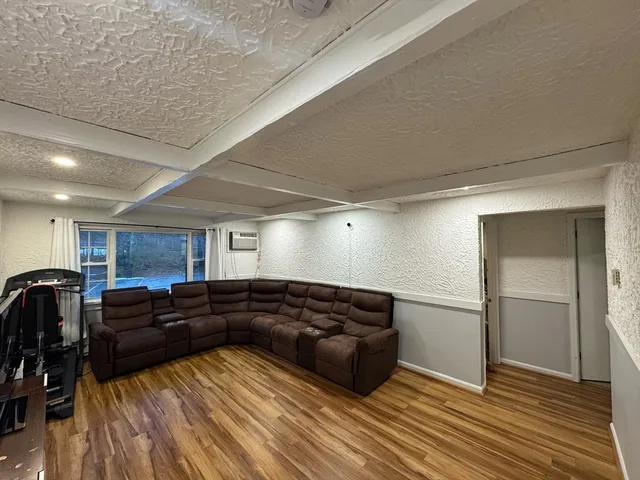 a large bedroom with a bed and a dresser