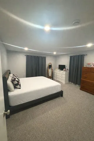 a bedroom with a bed and a couch