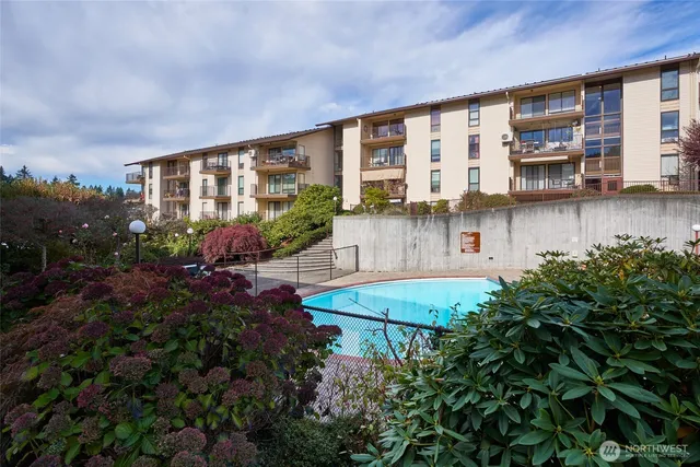 a view of a house with backyard and sitting area