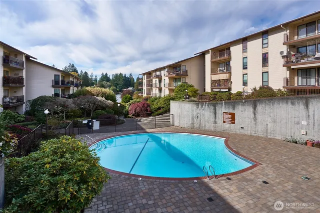 a swimming pool with outdoor seating and yard