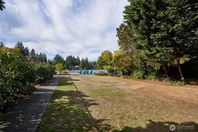 a kitchen with stainless steel appliances a sink a stove and white cabinets
