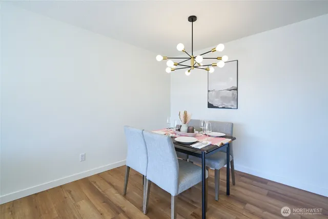 a view of a dining room with furniture wooden floor and a chandelier