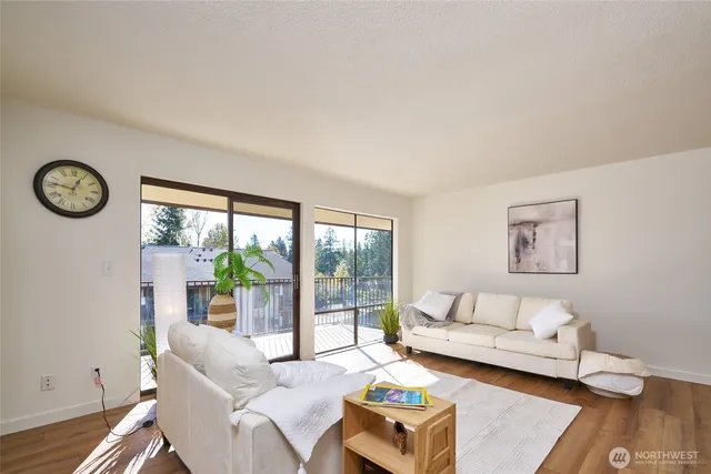 a living room with furniture and a floor to ceiling window