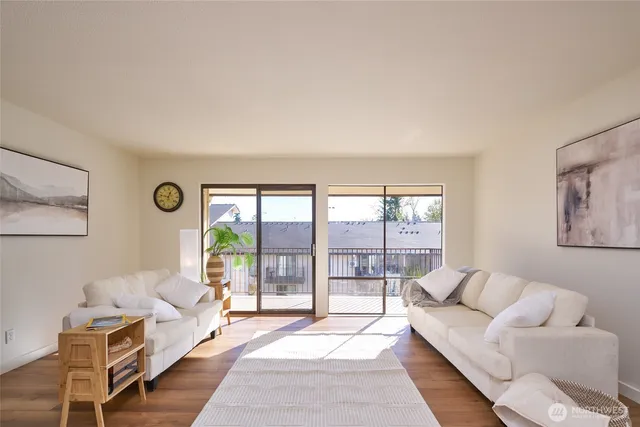 a living room with furniture and view of kitchen