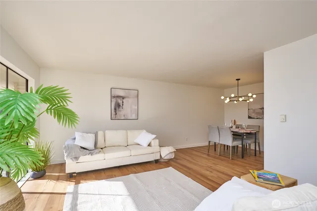 a kitchen with a refrigerator and a dining table