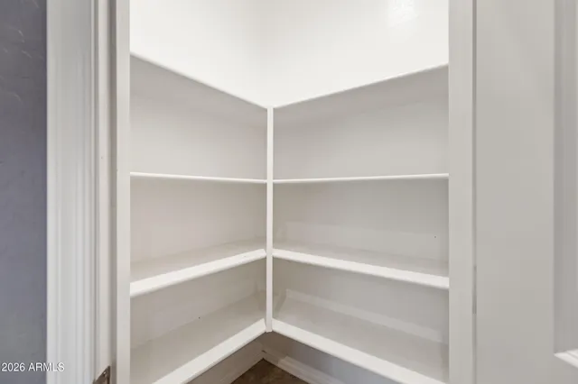 a large kitchen with a large counter top and stainless steel appliances