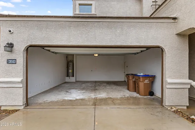 a view of a grey house with a yard