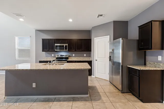 a kitchen with a sink stove and refrigerator