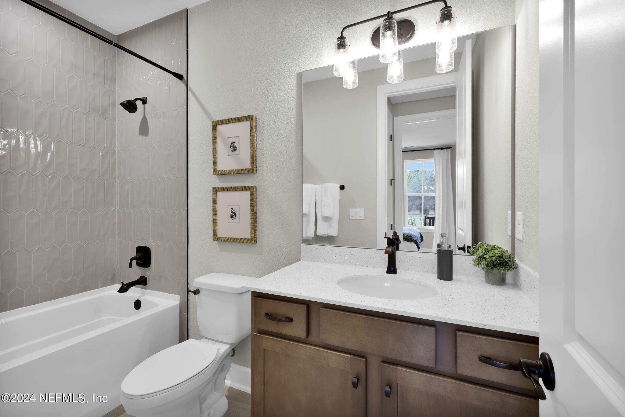 861 Goldenrod Drive St. Augustine, FL 32092 - Photo 11 of 83 a bathroom with a sink a toilet and a large mirror