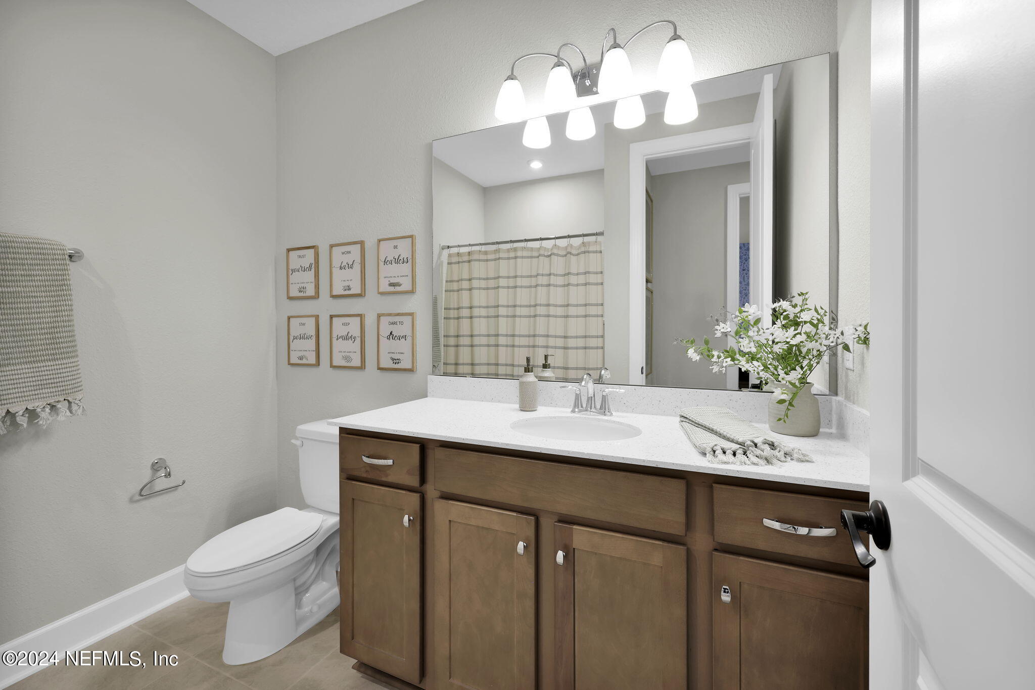 861 Goldenrod Drive St. Augustine, FL 32092 - Photo 13 of 83 a bathroom with a sink a toilet and a mirror