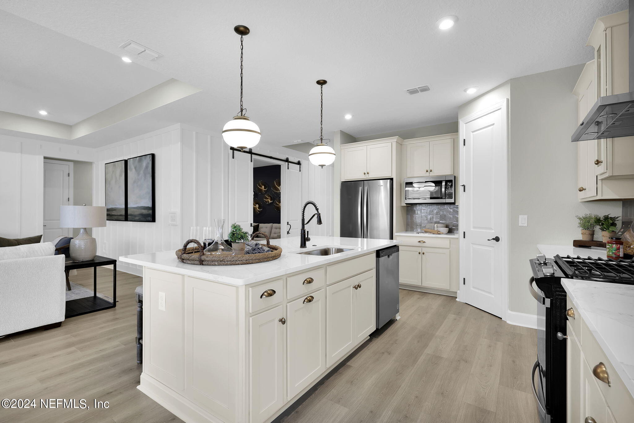 861 Goldenrod Drive St. Augustine, FL 32092 - Photo 38 of 83 a kitchen with stainless steel appliances kitchen island a sink stove and cabinets