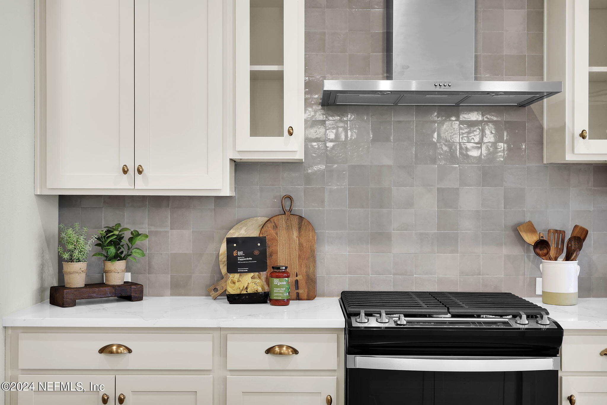 861 Goldenrod Drive St. Augustine, FL 32092 - Photo 40 of 83 a kitchen with stainless steel appliances granite countertop white cabinets and a stove