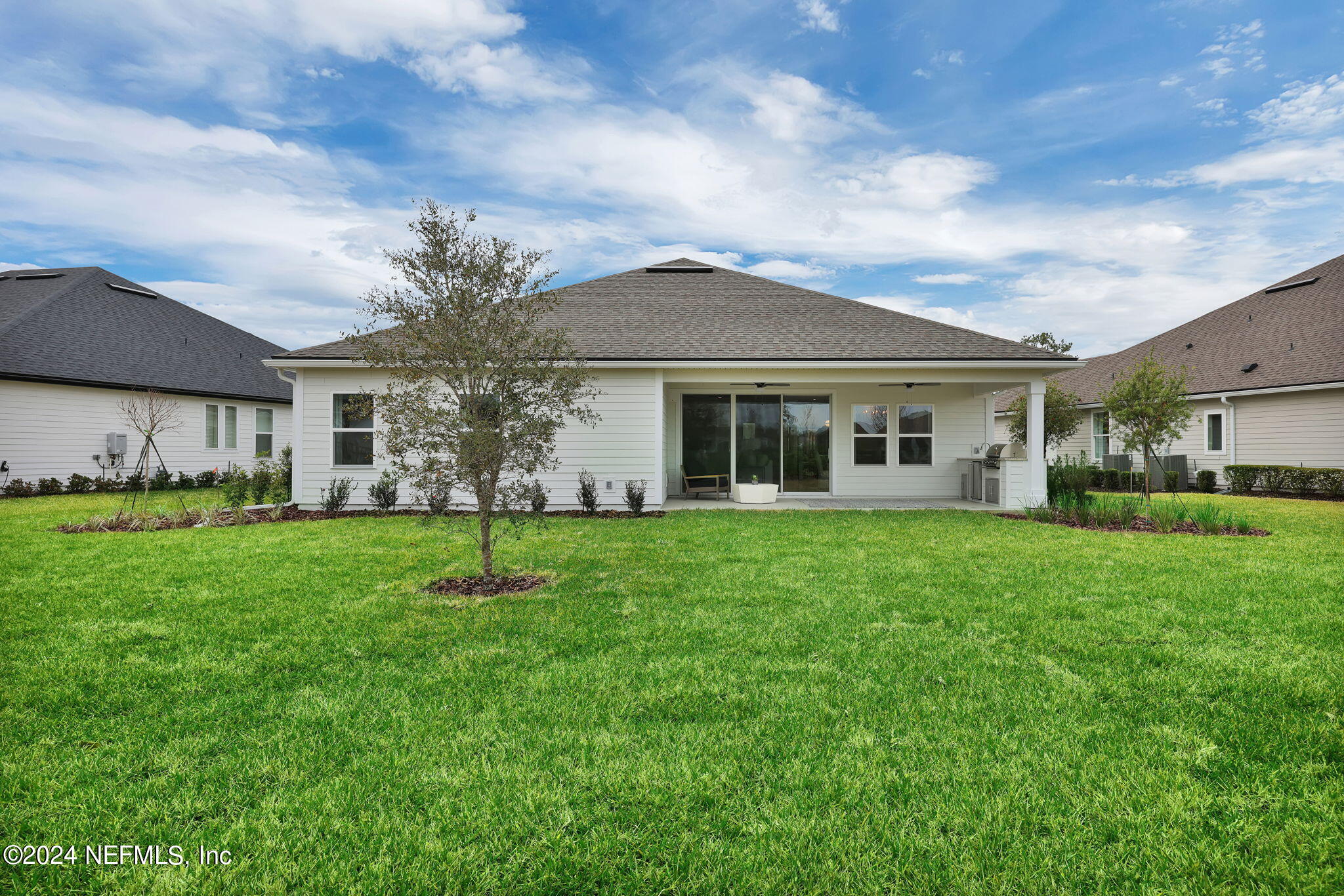 861 Goldenrod Drive St. Augustine, FL 32092 - Photo 9 of 83 a front view of a house with a garden
