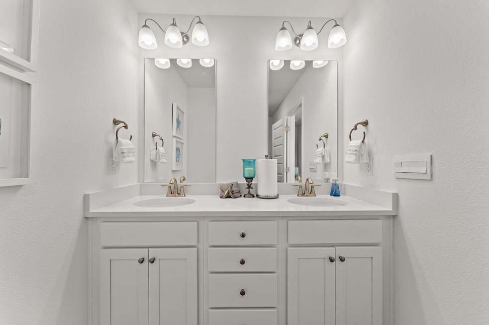 2 Redbird Loop Destin, FL 32541 - Photo 14 of 30 a bathroom with double vanity sinks a vanity a lamp and a mirror