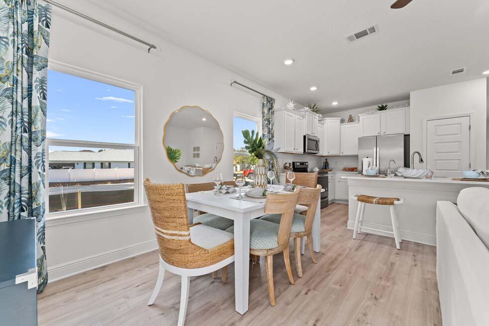 2 Redbird Loop Destin, FL 32541 - Photo 15 of 30 a view of a dining room with furniture and wooden floor