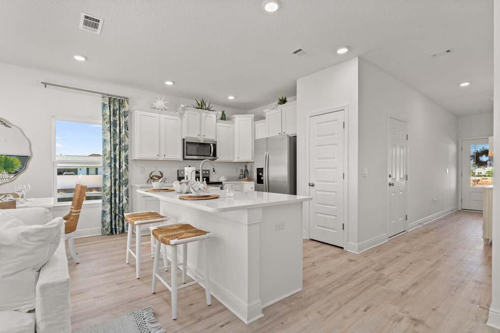 2 Redbird Loop Destin, FL 32541 - Photo 7 of 30 a kitchen with stainless steel appliances kitchen island granite countertop a refrigerator and a stove top oven