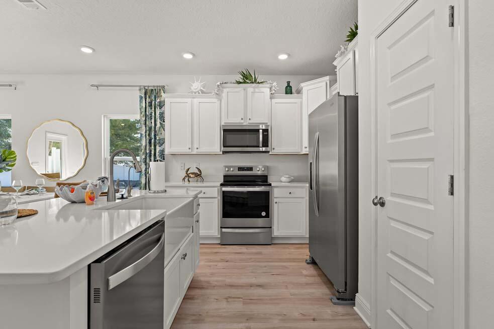 2 Redbird Loop Destin, FL 32541 - Photo 9 of 30 a kitchen with a sink stove and refrigerator